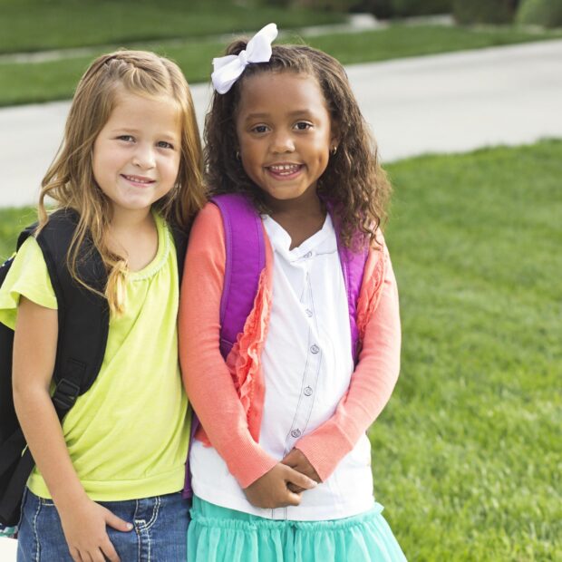 Cute Little girls walking to school together