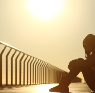 Girl sitting on bridge